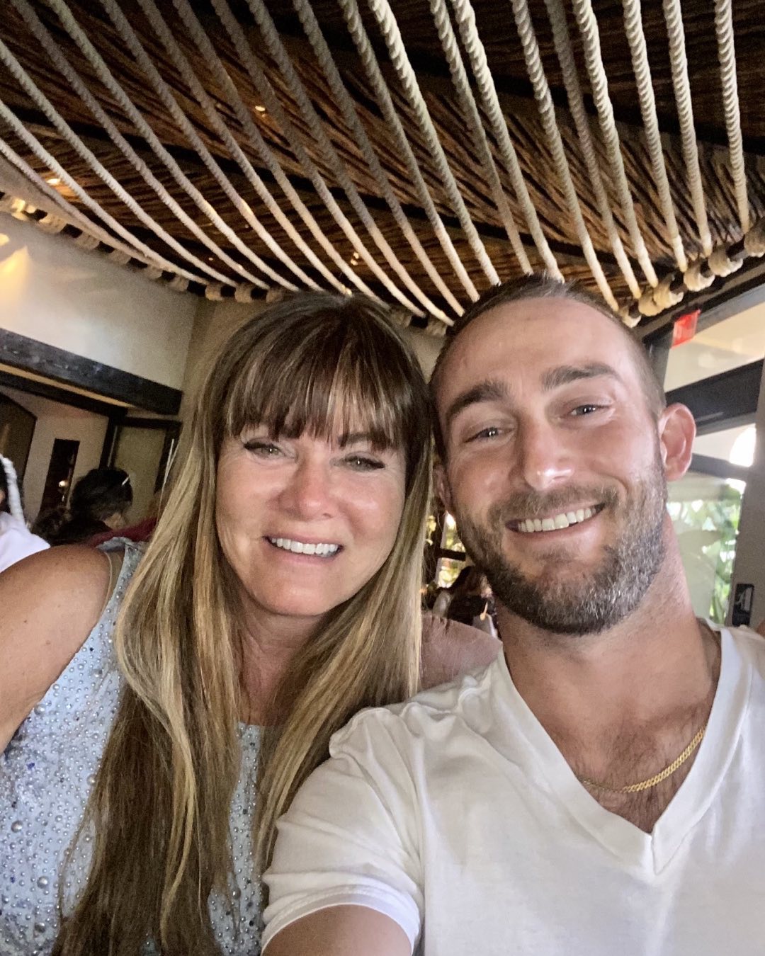 Woman with long blonde hair and a man with a beard smiling.