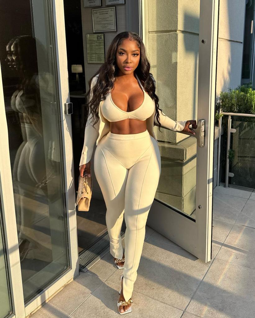Ayesha Howard posing in an off-white two-piece set with a matching blazer.