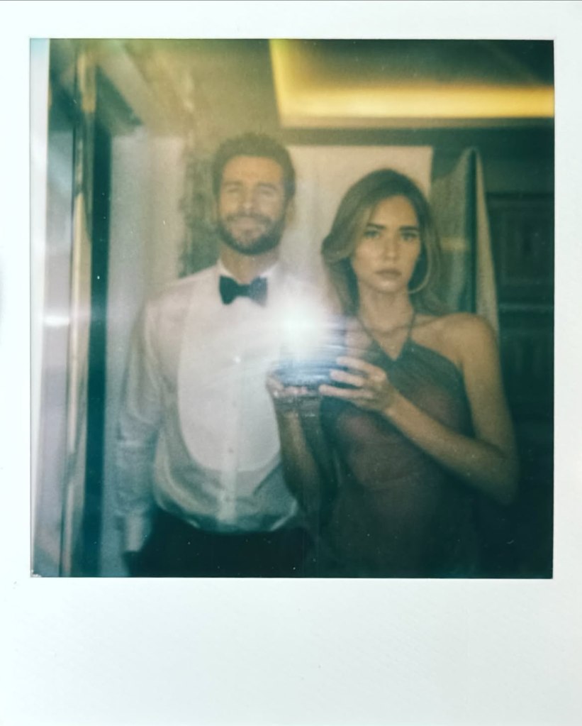 Polaroid photo of Liam Hemsworth and Matty Healy's ex posing for a mirror selfie.