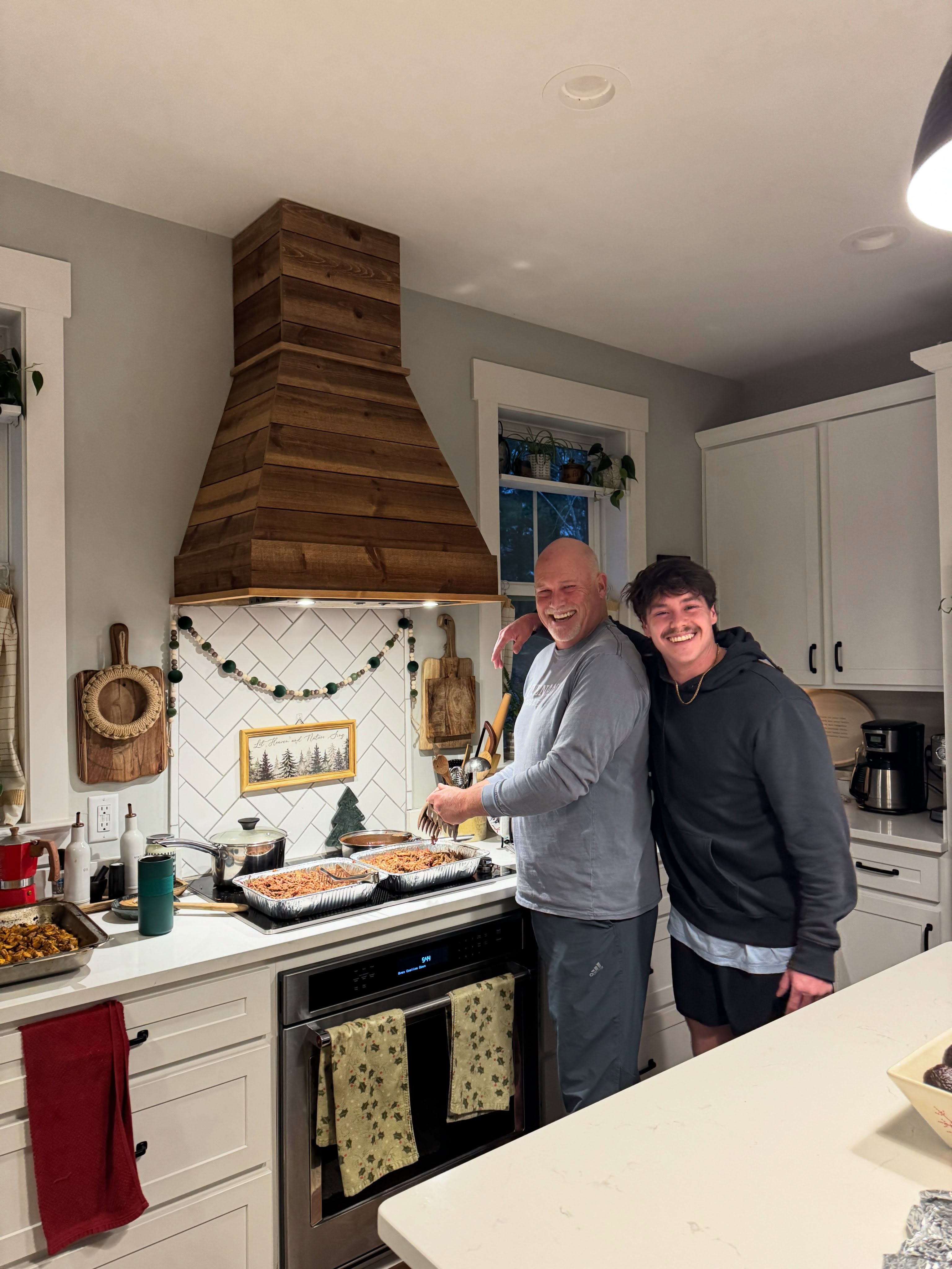 Zach John King and his father cooking in a kitchen.