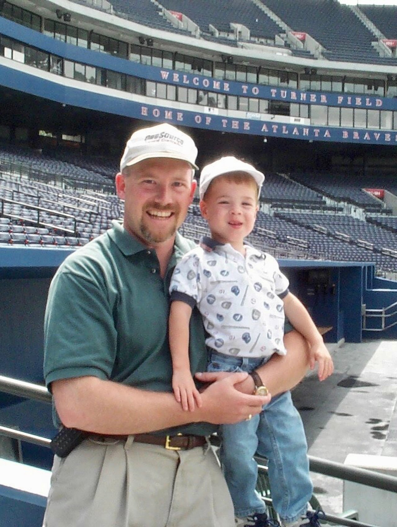 Zach King as a child held by his father at Turner Field.