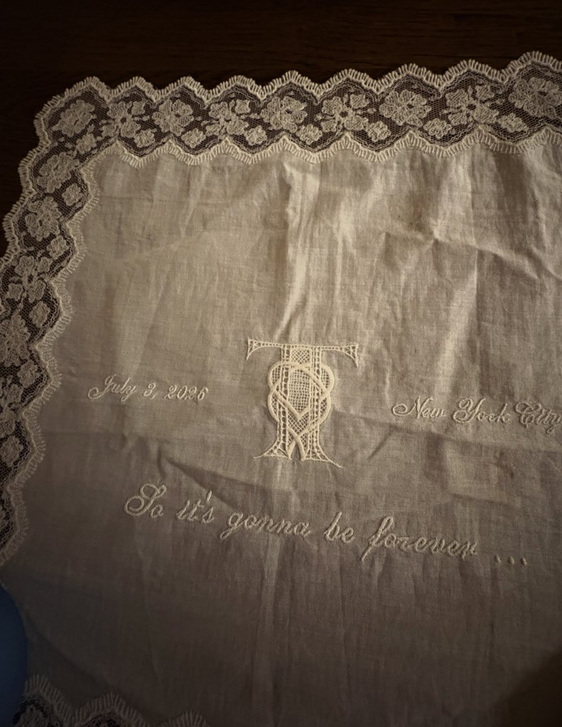 White cloth with lace trim embroidered with
