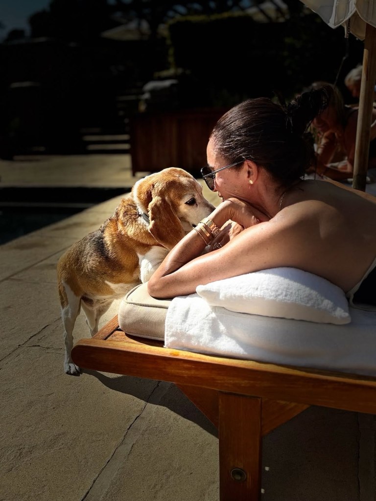 Meghan Markle with her beagle, Guy, on a sun lounger.