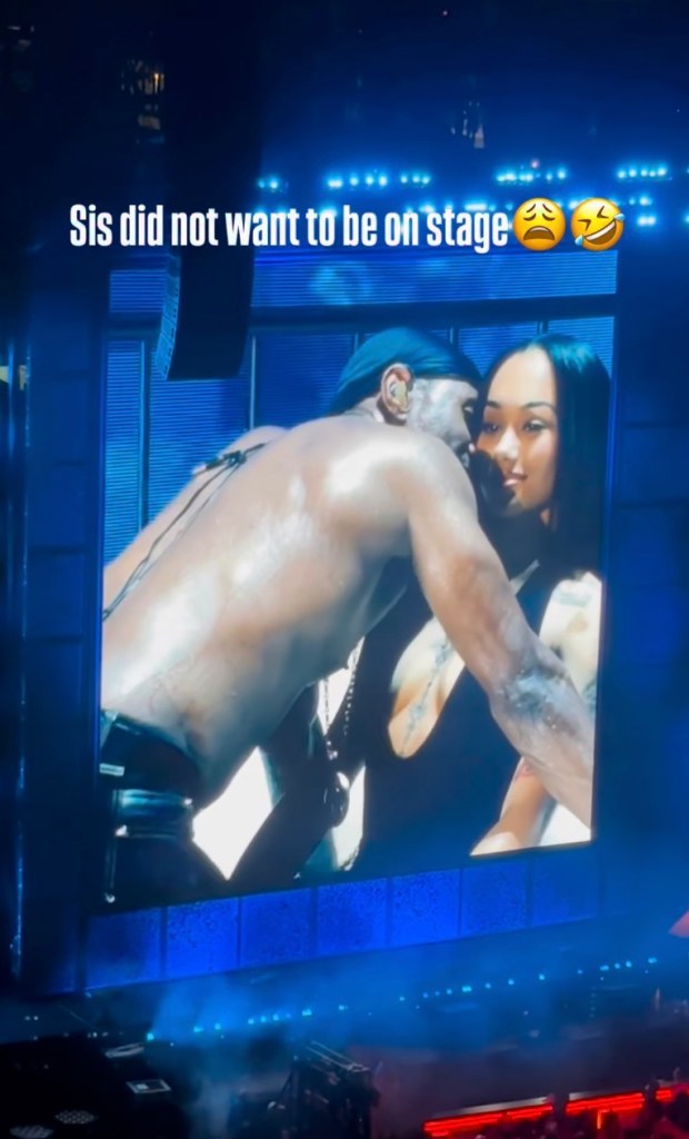 Usher reacting onstage to Gabrielle Cheyenne, who appears reluctant.