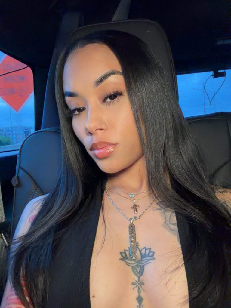Gabrielle Cheyenne posing in a car.
