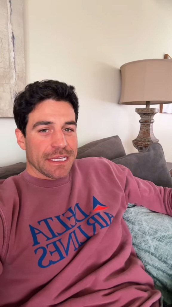 Joe Amabile of Bachelorette fame wearing a pink "Delta Airlines" sweatshirt.