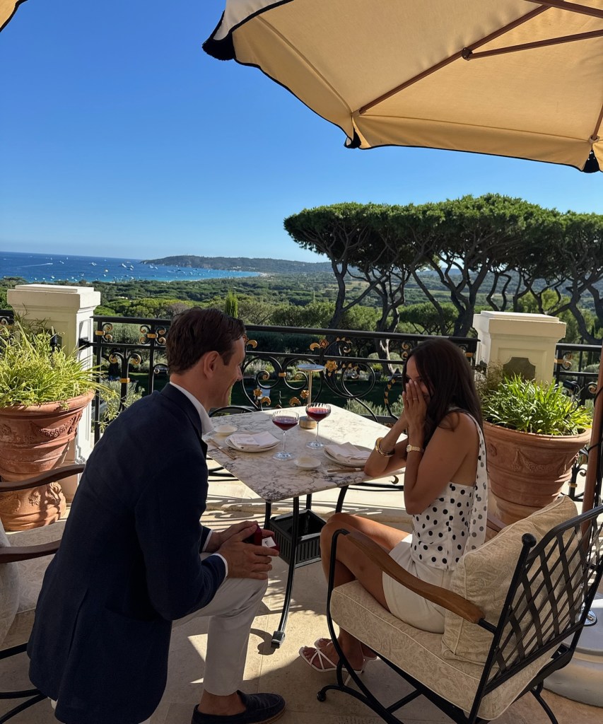 Sofia Franklyn, in a black and white spotted top and white skirt, with fiancé