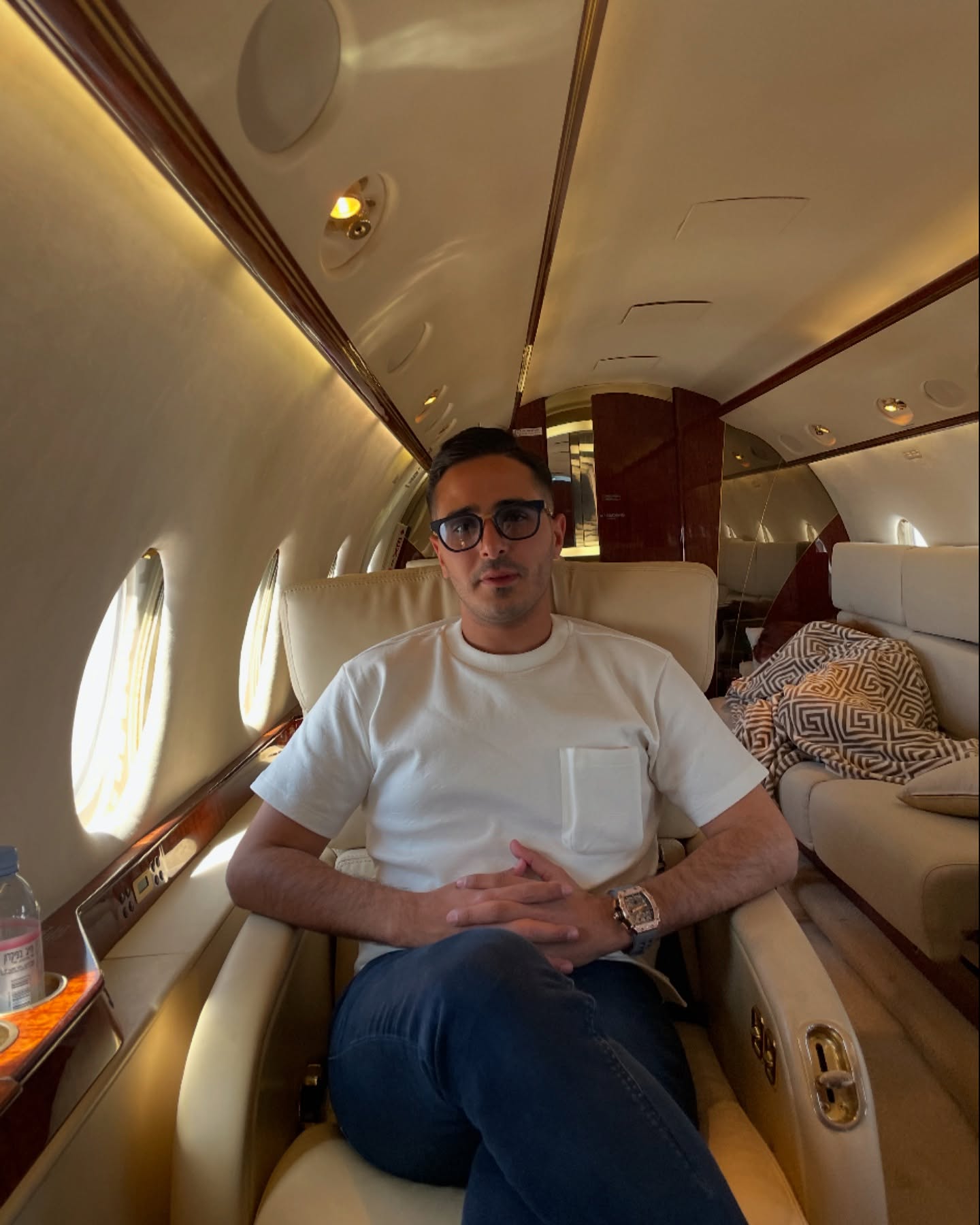 Simon Leviev sitting on a private jet.