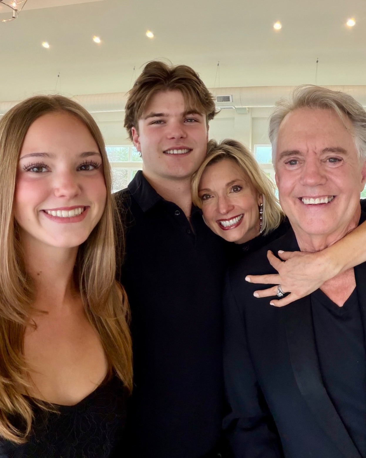 Shaun Cassidy and his wife and two children pose for a family photo.