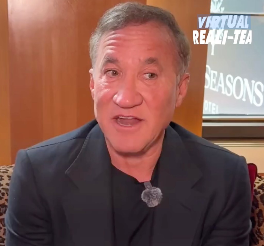 Terry Dubrow speaking, wearing a suit and lavalier microphone.