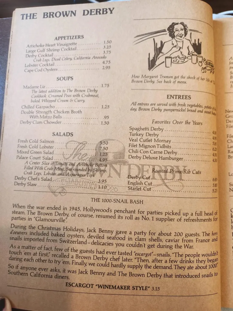 A vintage menu from The Brown Derby restaurant listing appetizers, soups, salads, and entrees, along with a story about Jack Benny introducing escargot to Southern California diners.