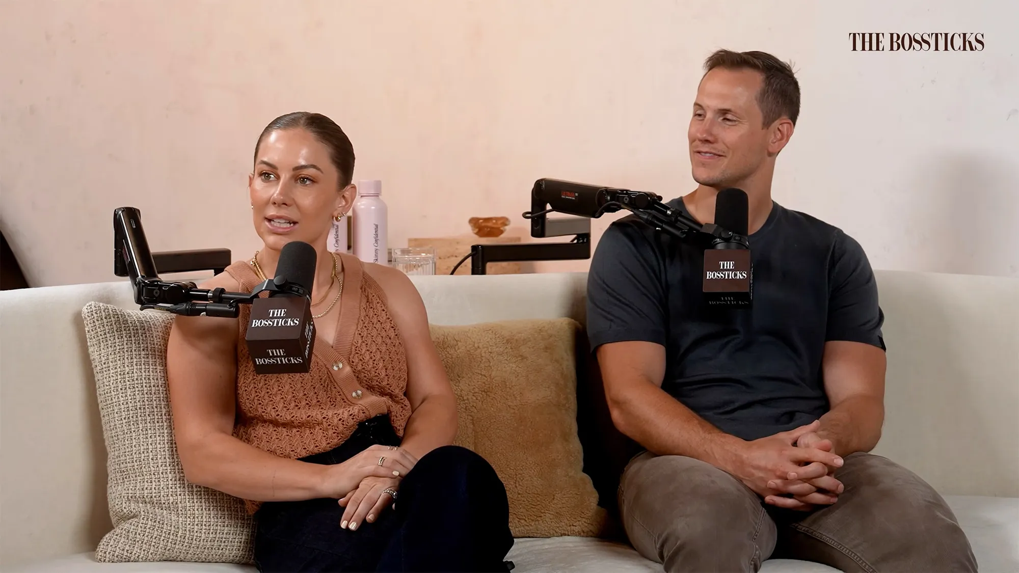 Shawn Johnson and Andrew East sitting on a couch for an interview.