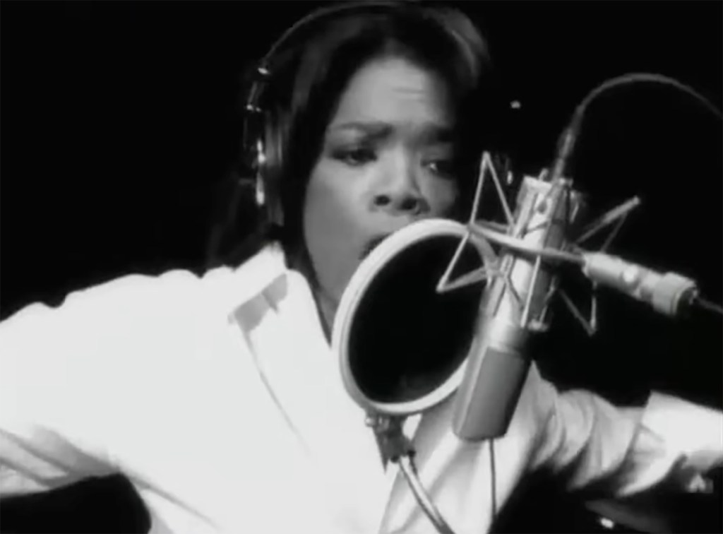 Oprah Winfrey singing into a microphone in a recording studio.