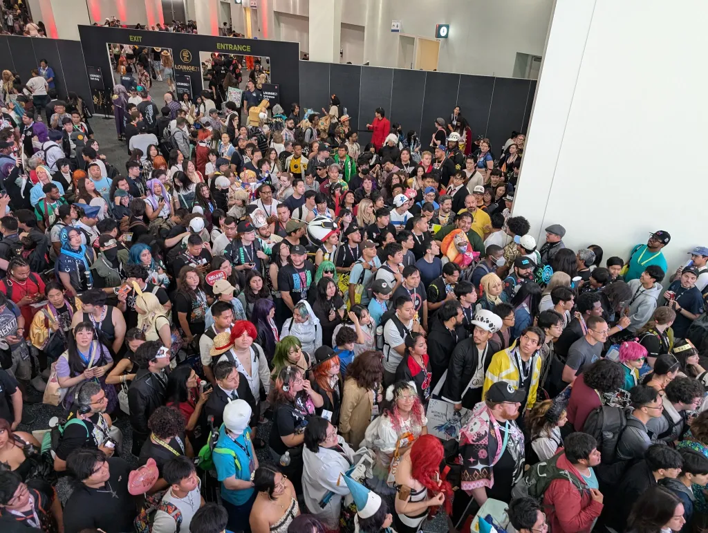 Large crowd of attendees at Anime Expo 2026, many in cosplay, gathered at the entrance to the convention.