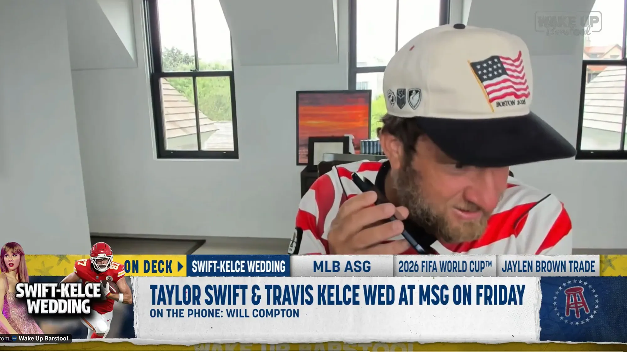 Dave Portnoy on a video call, wearing a white and black cap with an American flag and "Boston 106" embroidered on it, and a red and white striped shirt.