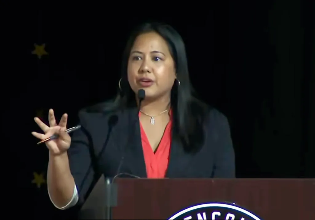 Ysabel Jurado, an American attorney and politician, speaking at a podium.