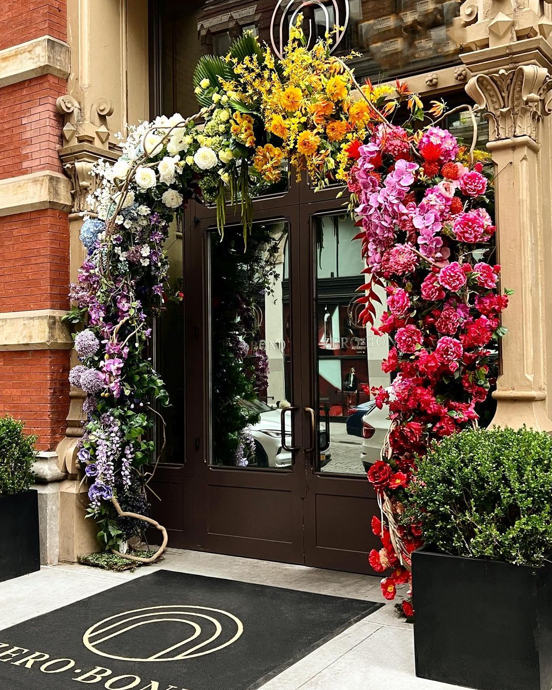 Zero Bond NYC entrance decorated with a colorful floral arch.
