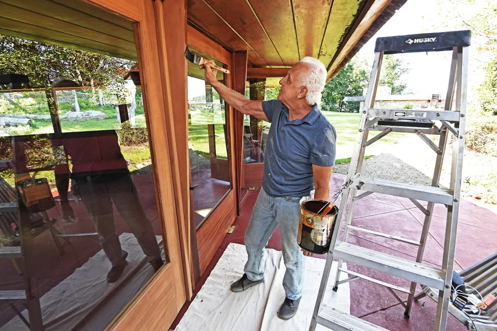Every 10 years, Massaro hires a local handyman, Daniel Corbi, to sand and stain the exterior wood enveloping both houses. The work is tedious and takes five years to complete.