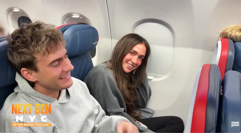 Man and woman on a plane smiling.