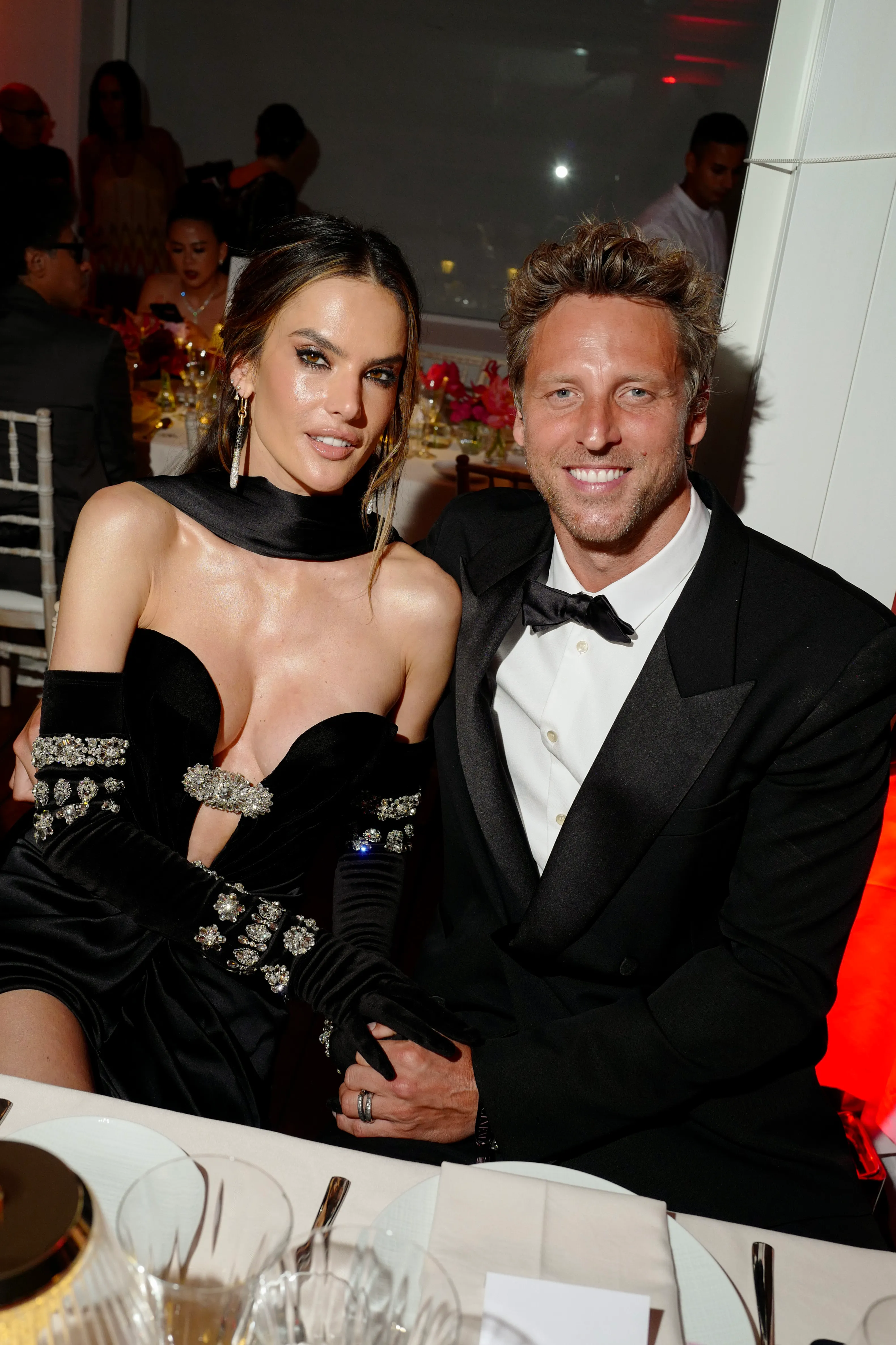 Alessandra Ambrosio and Buck Palmer seated at a table.