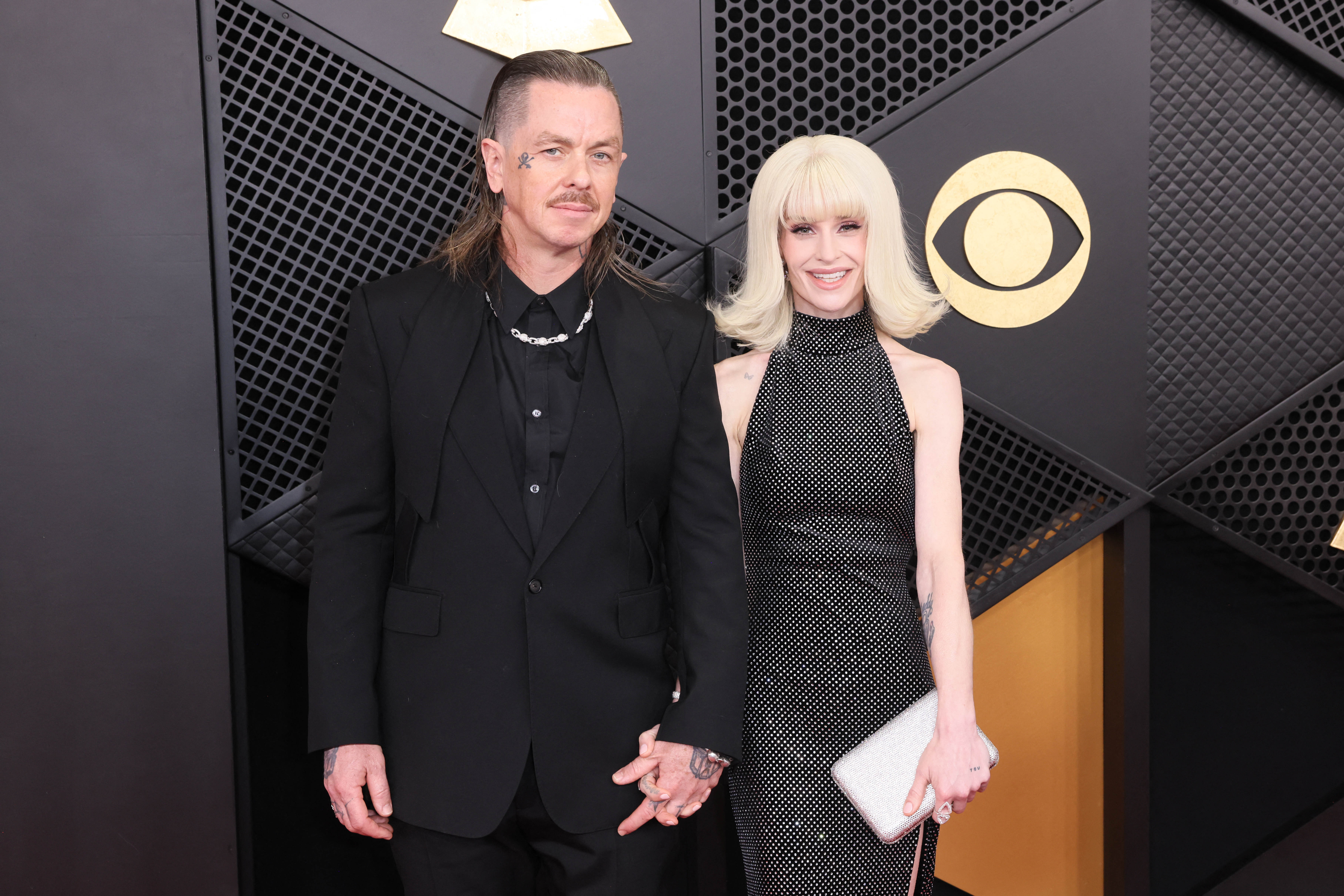 Sid Wilson and Kelly Osbourne holding hands at the 68th Annual Grammy Awards.