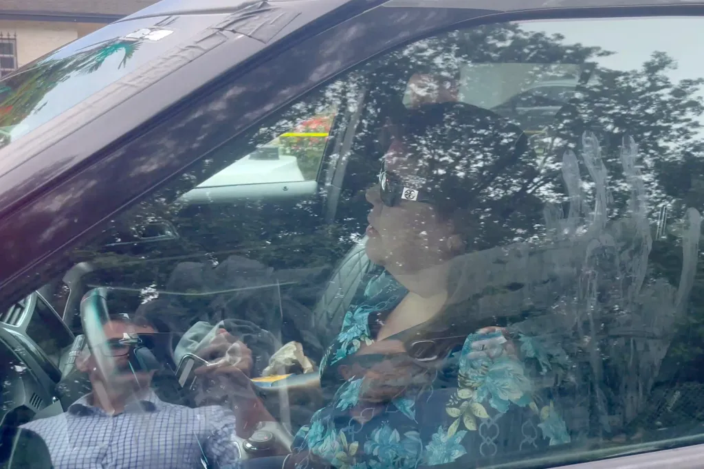Barbara Lavandeira, sister of Perez Hilton, talking to Miami-Dade County Sheriff's deputies inside a car.
