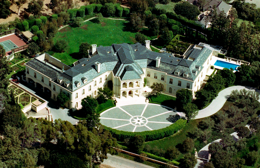 Aerial view of Aaron Spelling's Holmby Hills mansion, showing its extensive grounds, tennis court, and swimming pool.