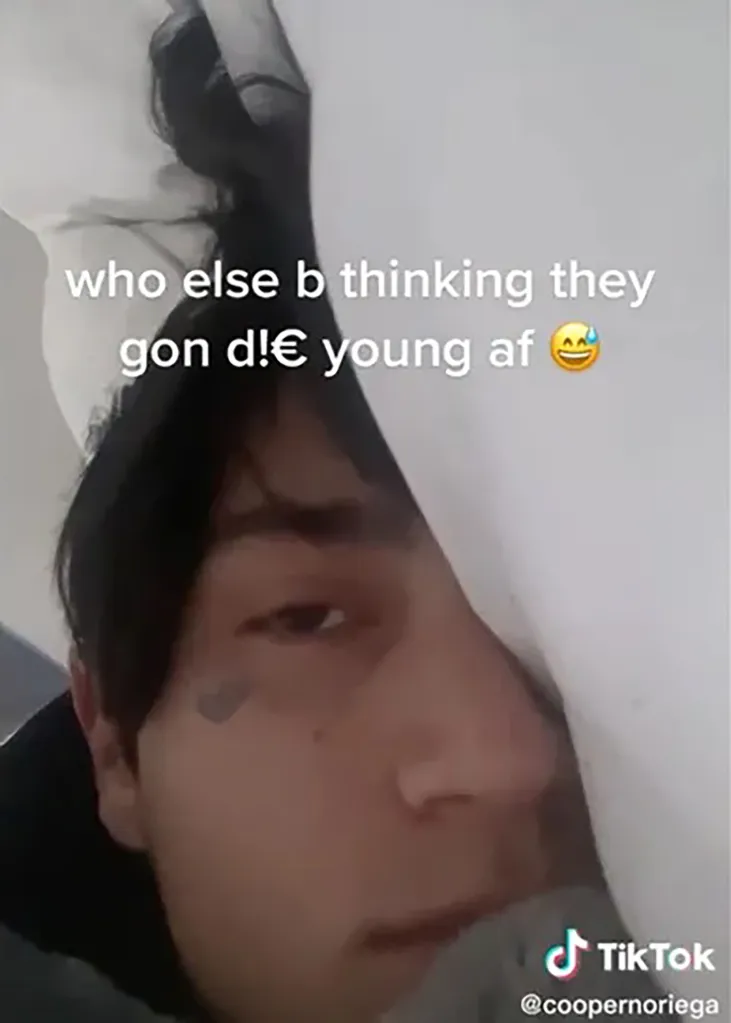 A young man with dark hair, a small black heart tattoo below his right eye, and a slight mustache, looks directly at the viewer from a social media post with the text "who else b thinking they gon d!€ young af 😂" overlaid.