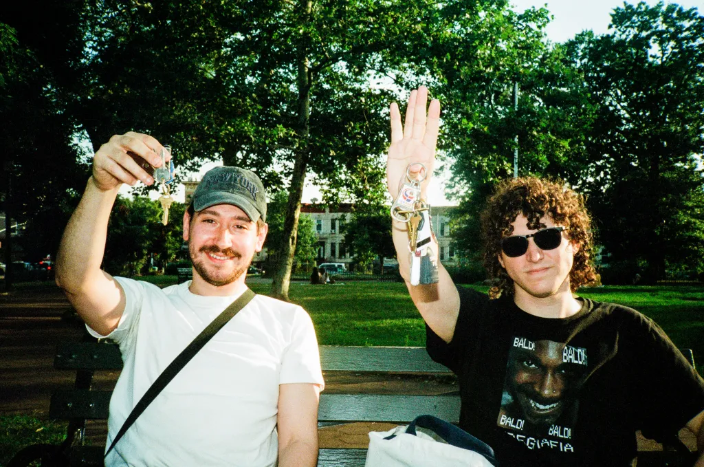 Joe Medina and Kyle Harvey posing with their apartment keys.