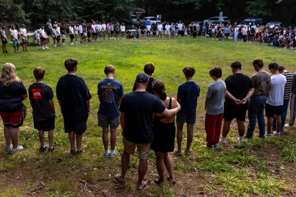 Community members gather during a student-organized vigil at Duncan Woods in Grand Haven, Mich., on Monday, July 27, 2026. 