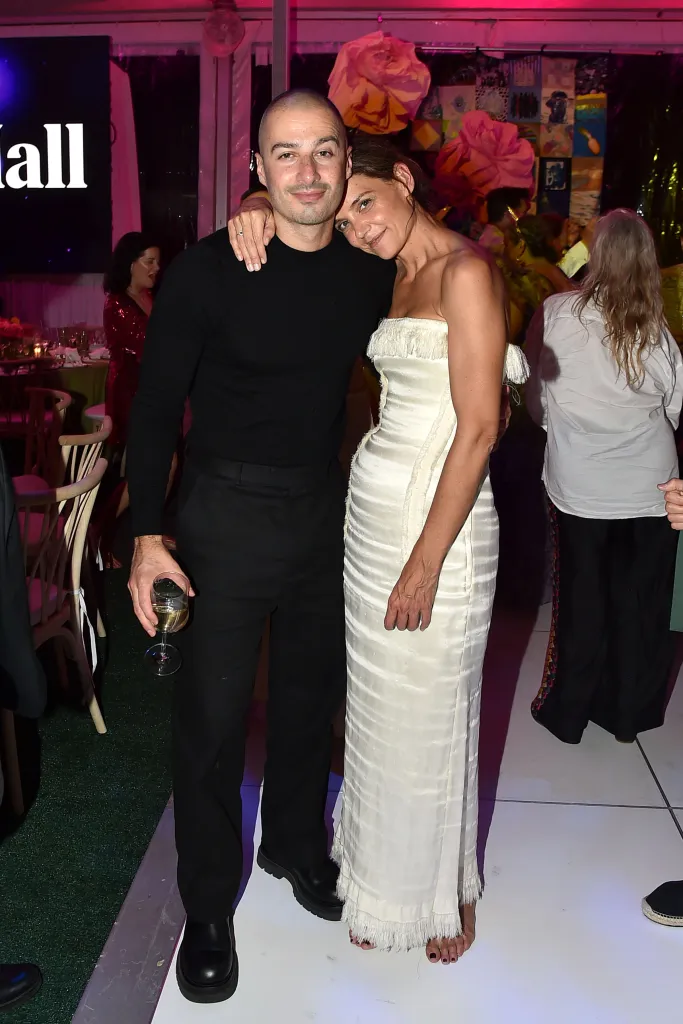 Katie Holmes and Jason Bard Yarmosky pose together, Yarmosky with his arm around Holmes as she leans her head on his shoulder.