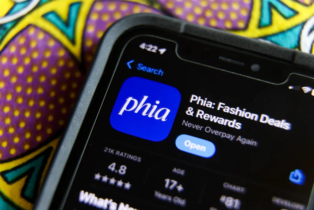 A close-up of a smartphone screen showing the Phia app listing in the Apple App Store.