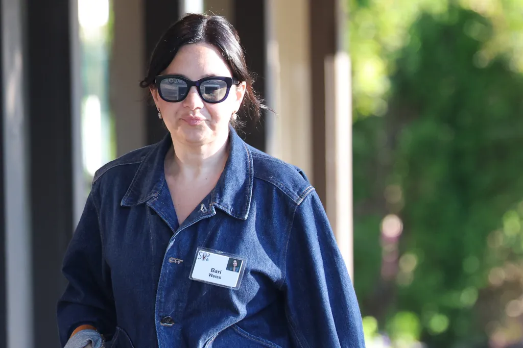 Bari Weiss, editor-in-chief of CBS News, wears sunglasses and a denim jacket with a name badge.