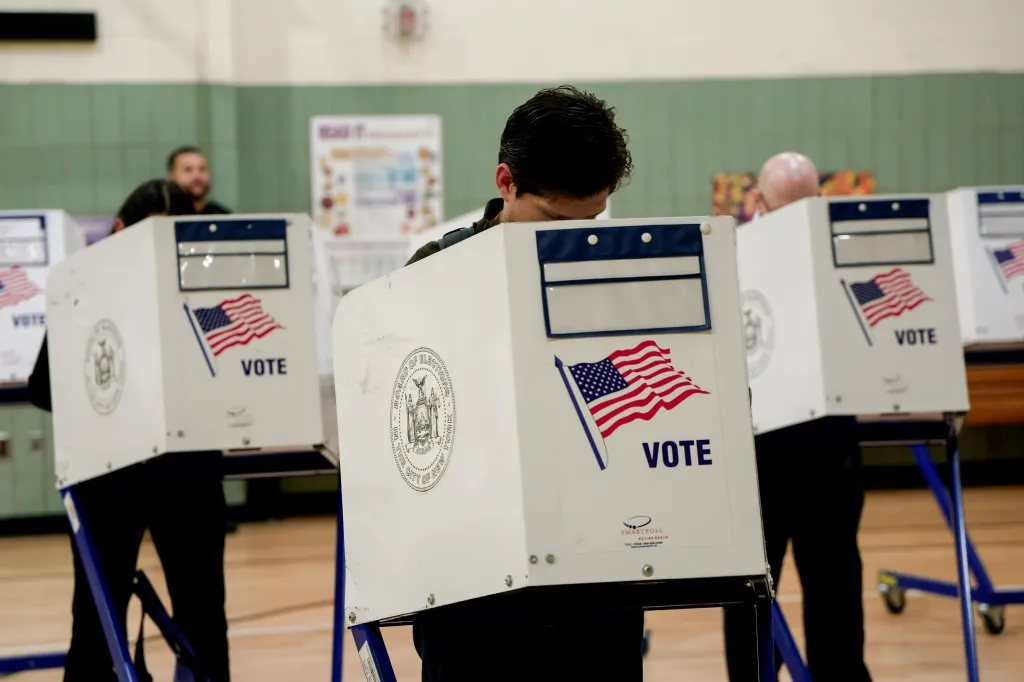 A voter casting their ballot in a voting booth during a primary election in New York.