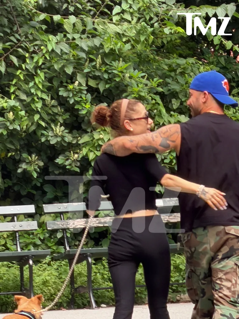 Ariana Grande and Ricky Alvarez in a park, with Alvarez's arm around Grande.