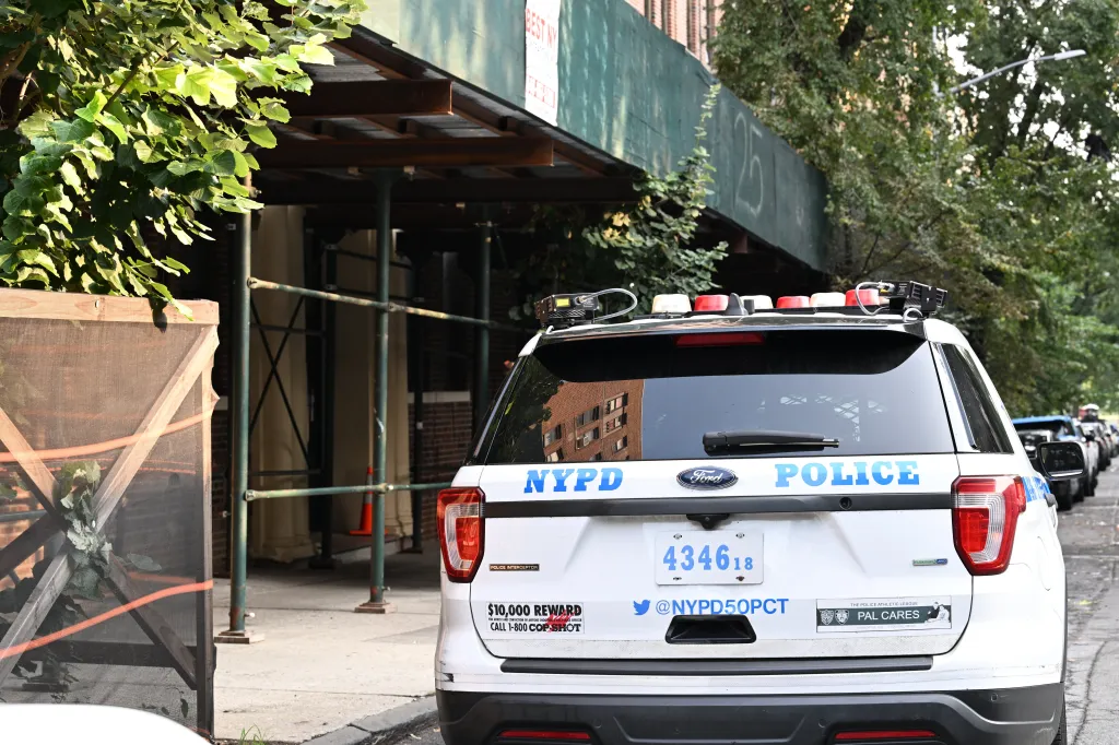 An NYPD police car is parked on the street outside 2825 Claflin Avenue in the Bronx, New York, where 15-year-old Riley Billingslea was fatally shot.