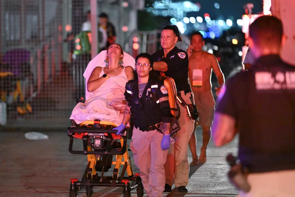 Emergency responders transporting a woman on a stretcher after a boat capsized off Liberty Island.