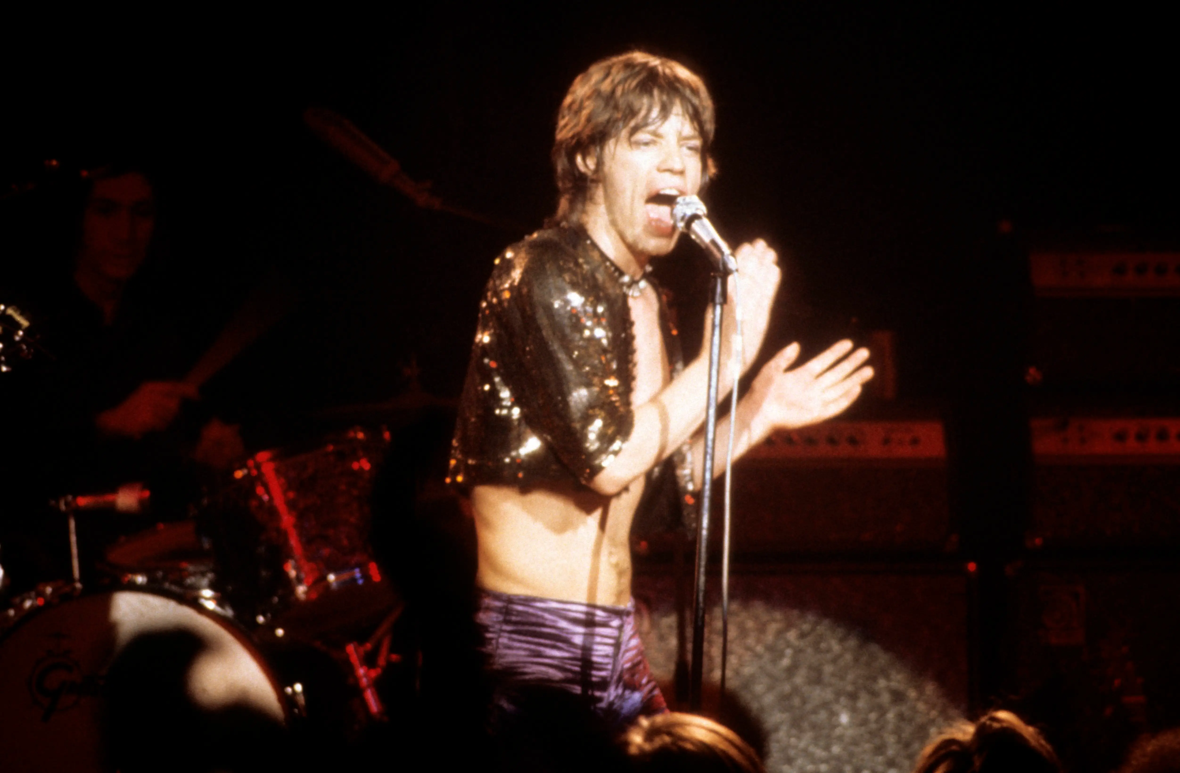 A spectacular leap from Mick Jagger on stage during the Rolling Stones' 1975 Tour of the Americas. 