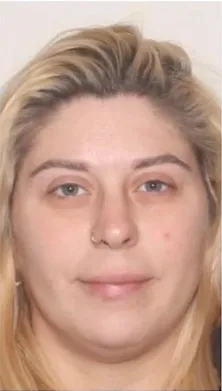 Headshot of a blonde woman with blue eyes and a nose ring, looking directly at the camera.