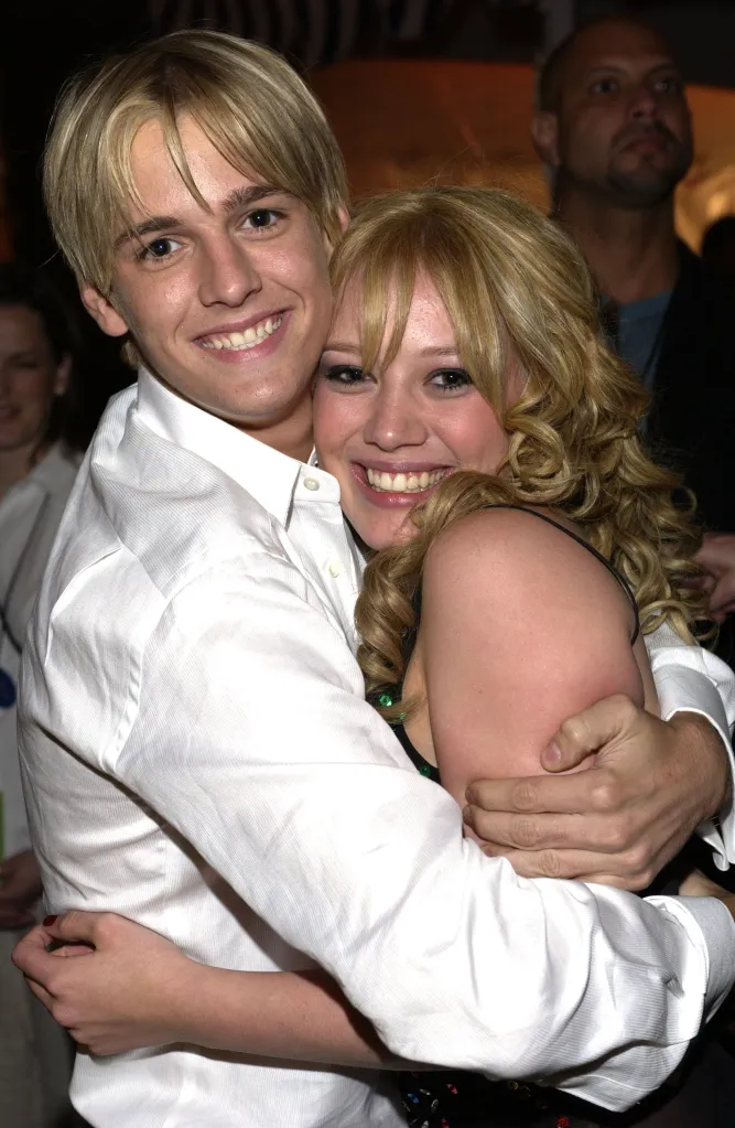 Aaron Carter and Hilary Duff hugging at The Lizzie McGuire Movie-Premiere After Party.