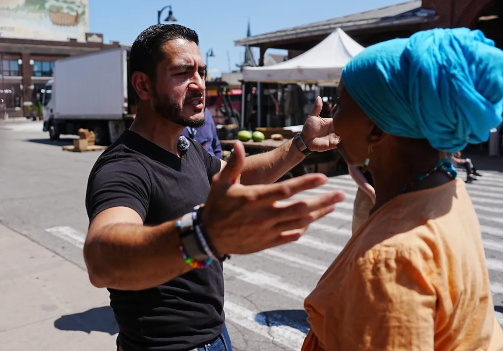 Abdul El-Sayed, Democratic candidate for U.S. Senate, talks with voters at Eastern Market in Detroit.