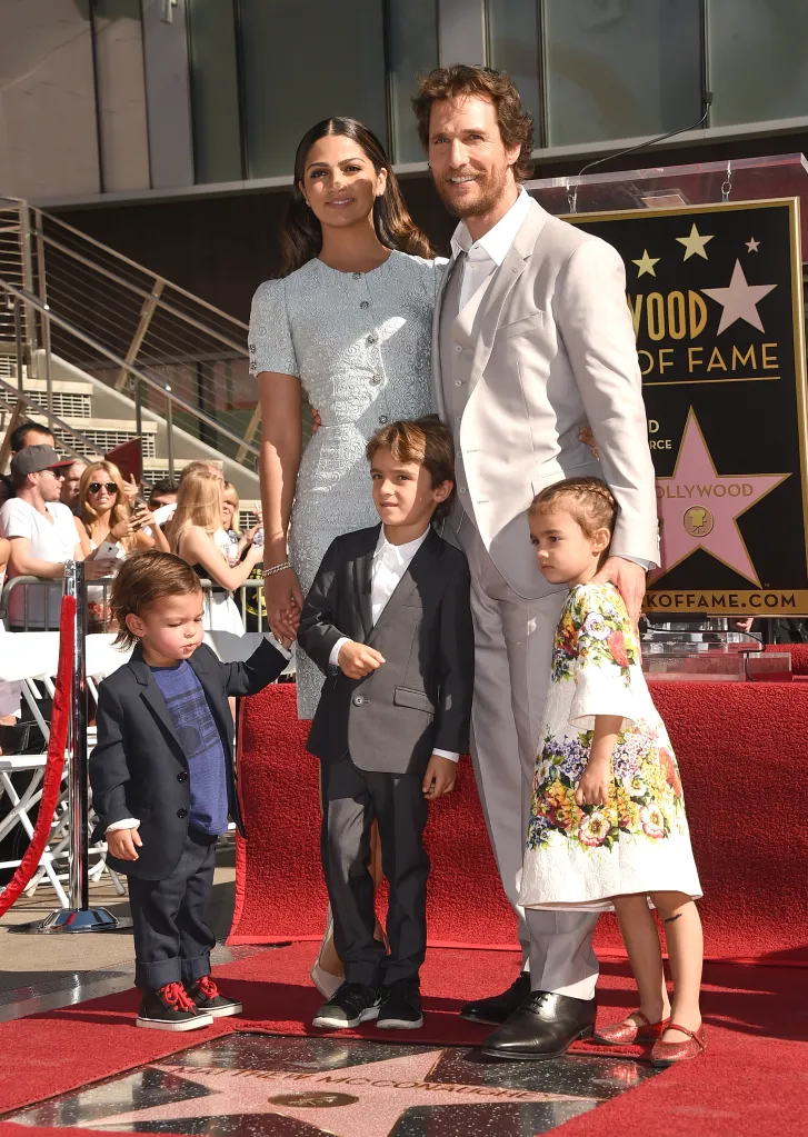 Matthew McConaughey with his wife Camila Alves and their three children, Levi, Livingston, and Vida, standing on the red carpet next to his star on the Hollywood Walk of Fame.