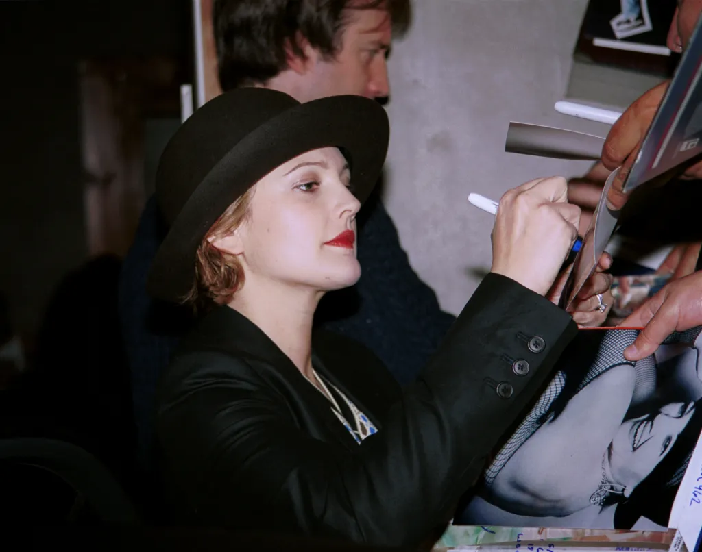 Drew Barrymore signing autographs at the premiere after-party for "Donnie Darko."
