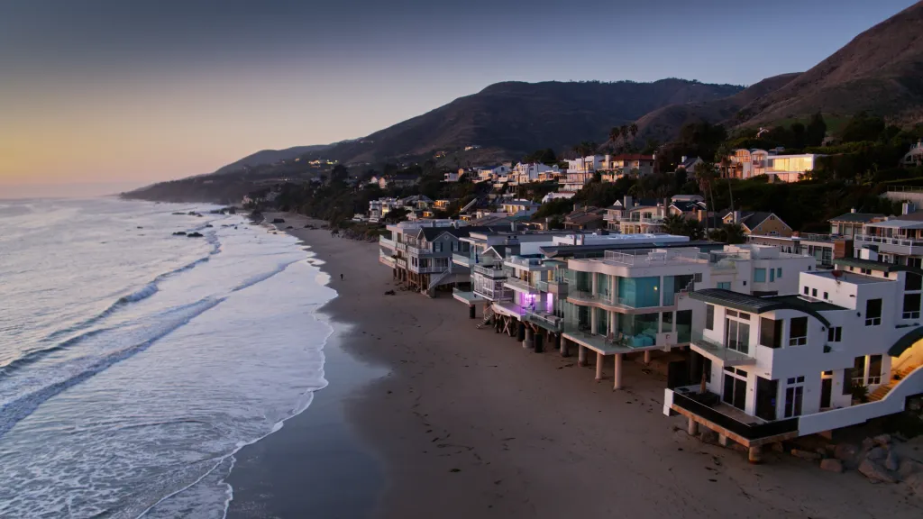 Aerial view of beach houses in Malibu, California at sunset.