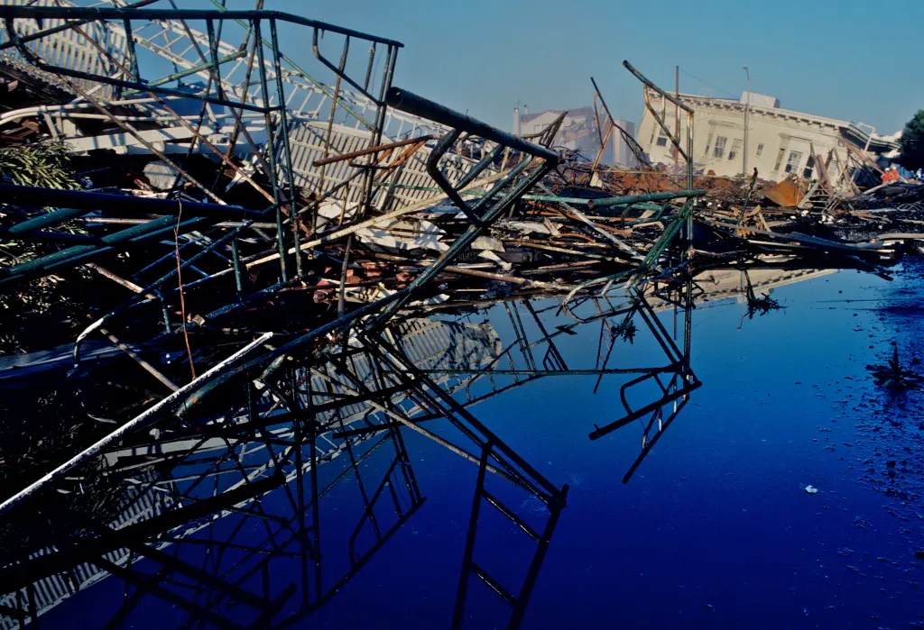 Debris from the Loma Prieta earthquake reflected in a pool of water.