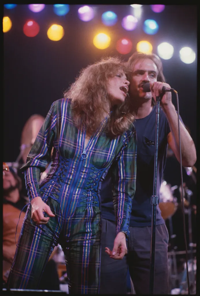Carly Simon and James Taylor singing on stage at the 'No Nukes' concert.