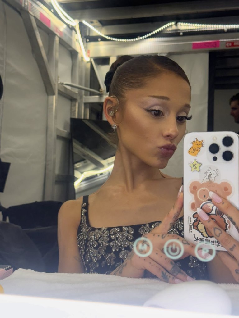 Ariana Grande taking a mirror selfie.