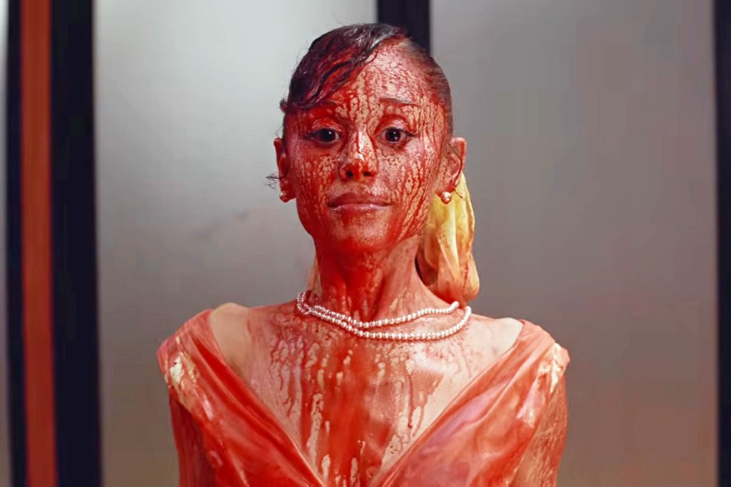Ariana Grande covered in red liquid in her new music video for her song "petal."