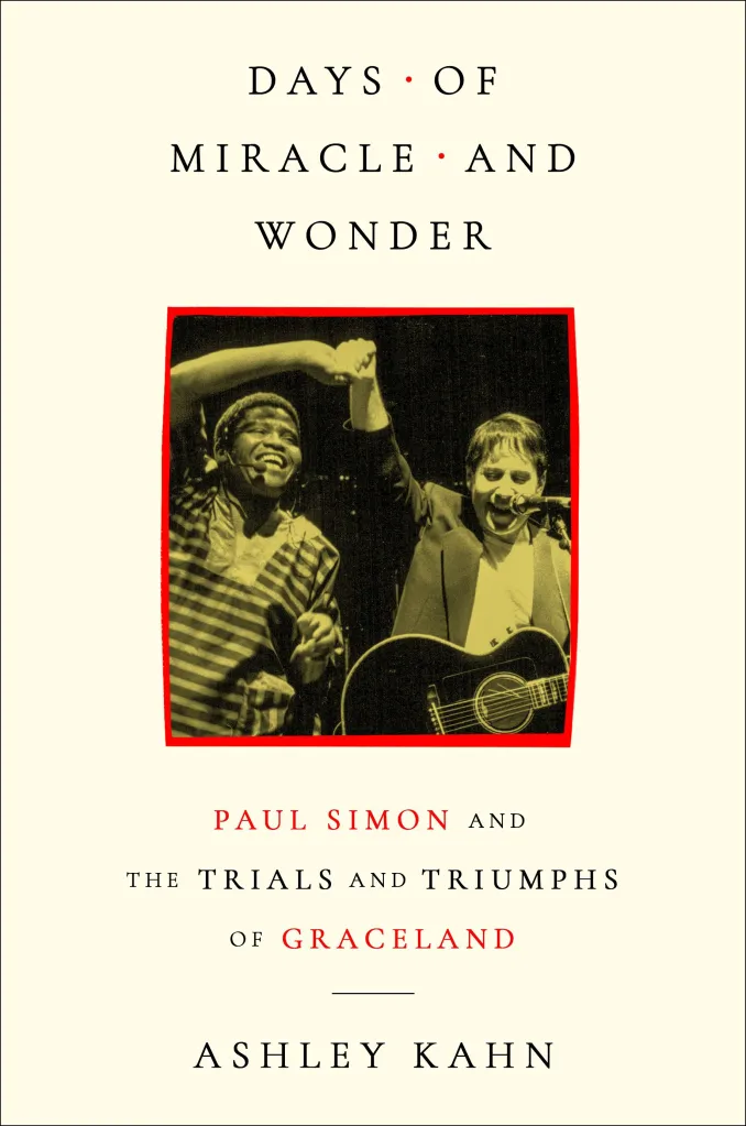 Book cover for "Days of Miracle and Wonder: Paul Simon and The Trials and Triumphs of Graceland" by Ashley Kahn, featuring an image of Paul Simon and another man raising their hands in celebration.