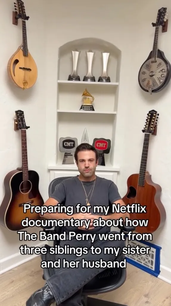Neil Perry in a chair with musical instruments and awards around him, with text discussing a Netflix documentary about The Band Perry.